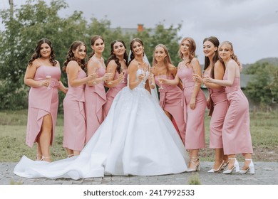 A beautiful bride and her bridesmaids are having fun in the morning. Wedding celebration. Happy girls at their best friend's wedding. A beautiful and elegant bride with her bridesmaids - Powered by Shutterstock