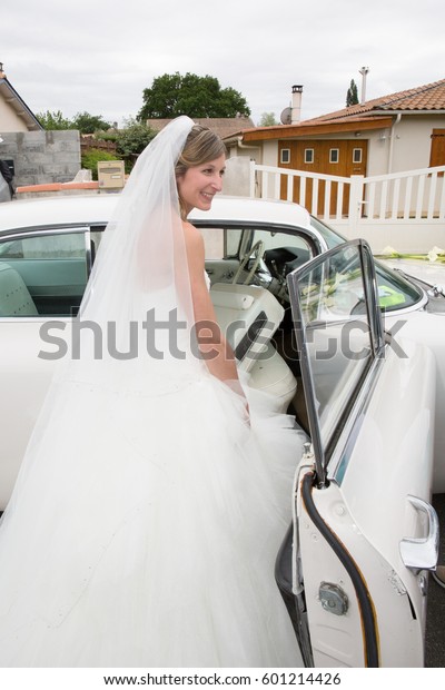 Beautiful bride\
on wedding car on her wedding\
day