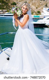 Beautiful Bride on the yacht  Portrait wedding makeup and hairstyle, girl in lace cathedral veil and marriage flowers bouquet, fashion bride gorgeous beauty, smiling happy bride portrait, series