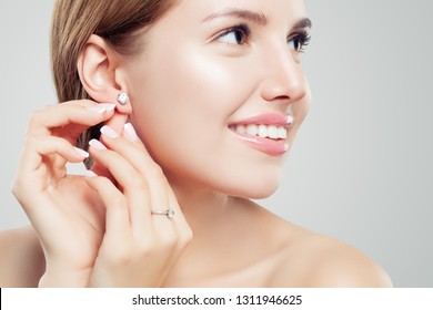 Beautiful Bride In Puts On Diamond Earring. Beauty Model Girl In Wedding Jewelry, Perfect Face Closeup