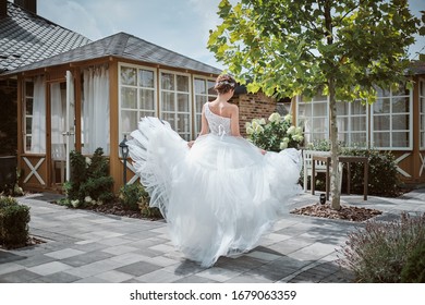 Beautiful Bride Running Away In The Garden