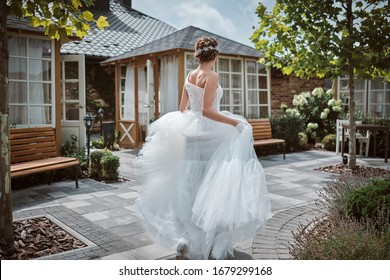 Beautiful Bride Running Away In The Garden