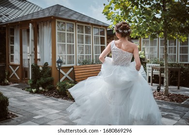 Beautiful Bride Running Away In The Garden