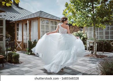 Beautiful Bride Running Away In The Garden