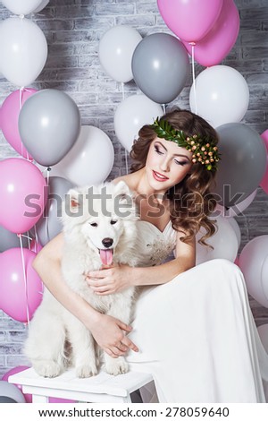 Beautiful bride with a Samoyed dog