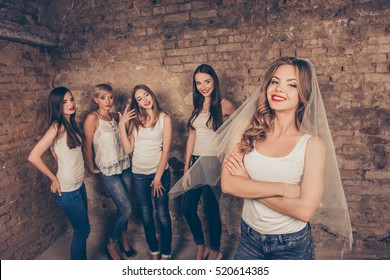 Beautiful bride standing in front of her bridesmaids celebrating hen-party