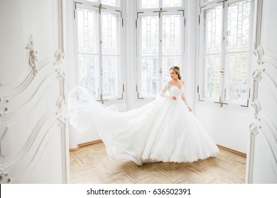 The beautiful bride stands in the room