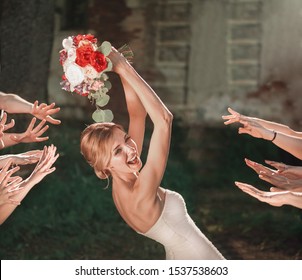 beautiful bride throws wedding bouquet to her friends - Powered by Shutterstock