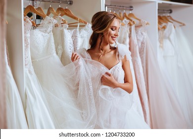 Beautiful Bride Is Trying On An Elegant Wedding Dress In Modern Wedding Salon