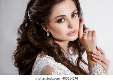 Beautiful Bride wedding makeup and hairstyle, vogue girl with long curly brown hair in white dress,  fashion model jewelry and beauty face, gorgeous arabian female, isolated , studio, series.
