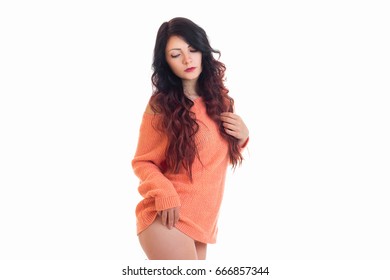beautiful bright brunette posing in the Studio in a long jacket