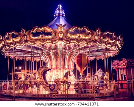 beautiful bright carousel in park at night in winter