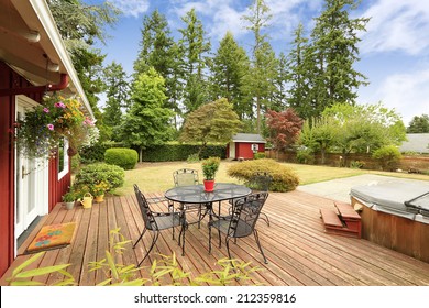 Beautiful Bright Red House With Patio Area On Walkout Deck And Small Red Shed On Backyard