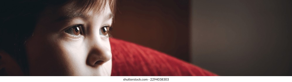 Beautiful brown eyes of 6 year boy looking at screen close-up. Child is watching TV, cartoons or video too long. Side view. The concentrating kid. Plays computer game. Vision load. Attention. - Powered by Shutterstock