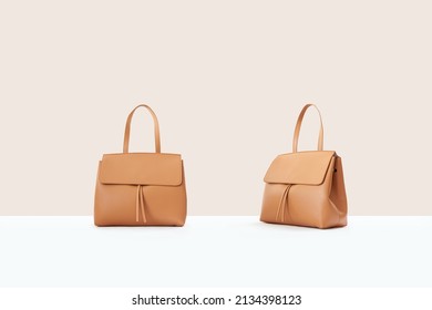 Beautiful brown leather female fashion bag isolated on light beige background, front view - Powered by Shutterstock