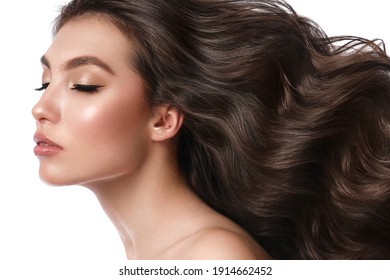 Beautiful Brown-haired Girl With A Perfectly Curls Hair, And Classic Make-up. Beauty Face And Hair. Picture Taken In The Studio.