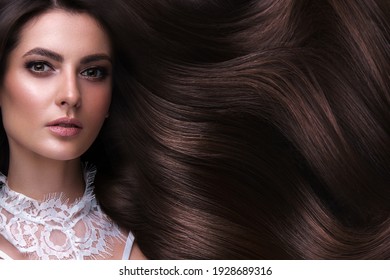 Beautiful brown-haired girl with a perfectly curls hair, and classic make-up. Beauty face and hair. Picture taken in the studio. - Shutterstock ID 1928689316