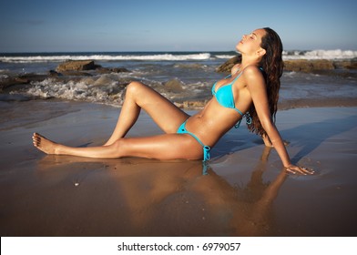 Beautiful Brunette In Blue Bikini On Beach