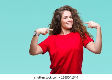 Beautiful brunette curly hair young girl wearing casual look over isolated background looking confident with smile on face, pointing oneself with fingers proud and happy.