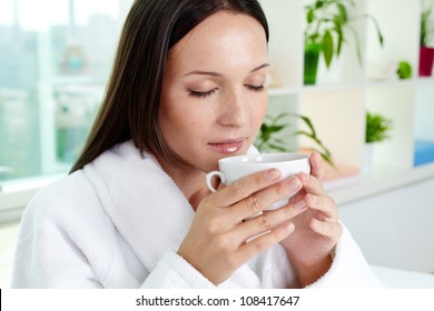 Beautiful Brunette Drinking Herbal Tea After Spa Procedures