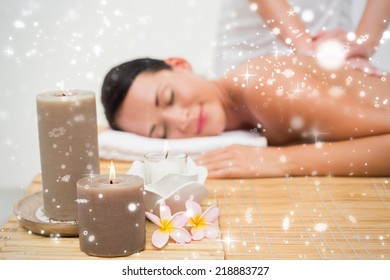 Beautiful brunette enjoying a back massage against snow falling