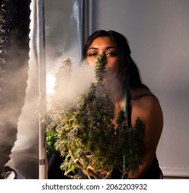 Beautiful brunette enjoys a smoke.