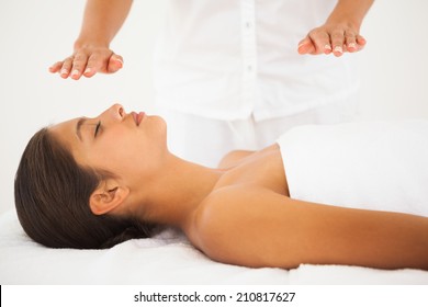 Beautiful Brunette Getting Reiki Therapy At The Health Spa