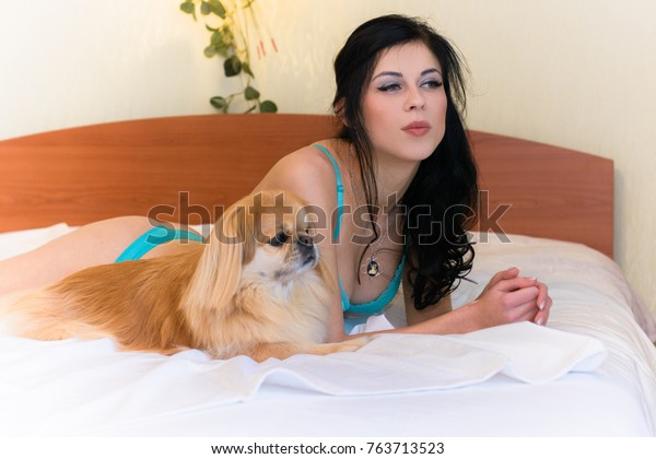 Cute brunette gets doggied on her bed