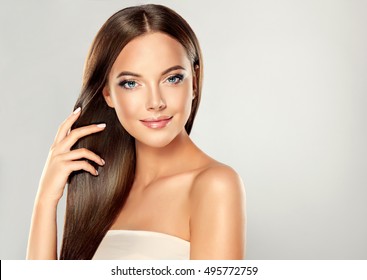 Beautiful Brunette Girl With Long And Straight Brown Hair . Shiny Smooth  And Healthy Well-groomed Hair .