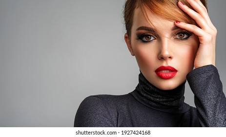 Beautiful brunette girl with red lips and short, slick hair. Pretty young sensual woman with red nails. Closeup portrait of a model with bright makeup on a face. Attractive female posing at studio. 