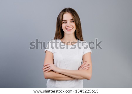 beautiful brunette girl smiling isolated over grey background