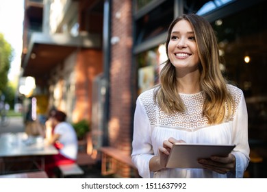 Beautiful brunette girl using tablet for work, freelance, blogging, studying, shopping