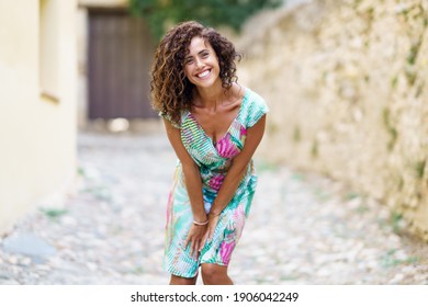 Beautiful Brunette Middle-aged Woman In Her 40s Wearing Spring Colorful Dress Outdoors.