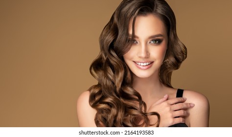 Beautiful brunette model  girl  with long curly  hair . Smiling  woman hairstyle wavy curls .  Fashion , beauty and makeup portrait - Shutterstock ID 2164193583