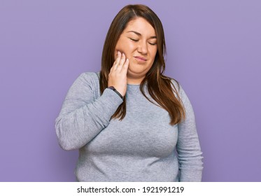 Beautiful Brunette Plus Size Woman Wearing Casual Clothes Touching Mouth With Hand With Painful Expression Because Of Toothache Or Dental Illness On Teeth. Dentist 