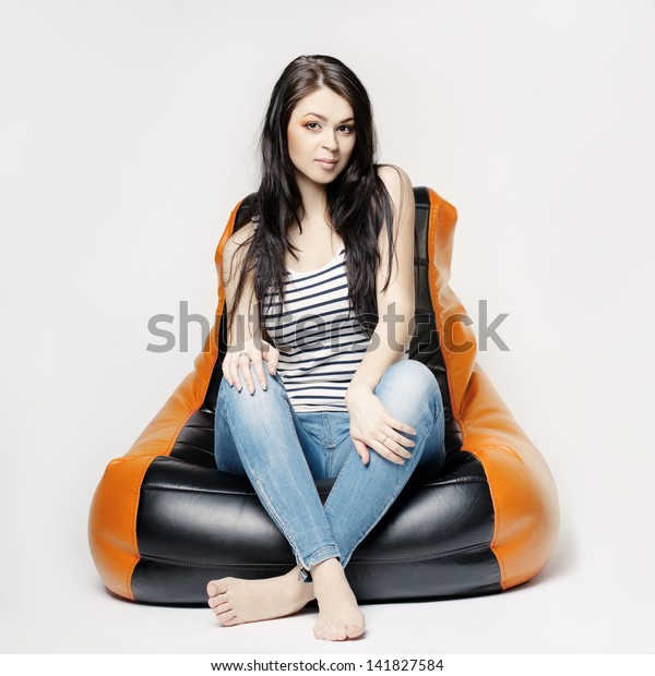 Beautiful Brunette Sitting On Beanbag Stock Photo (Edit Now) 141827584