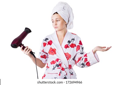 Beautiful Brunette Woman In Bathrobe And Towel On Her Head With Broken Hairdryer In Her Hands Confused What To Do