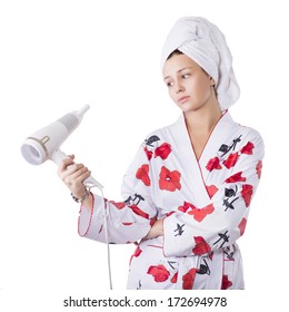 Beautiful Brunette Woman In Bathrobe And Towel On Her Head With Broken Hairdryer In Her Hands Confused What To Do