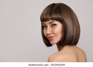 Beautiful Brunette Woman With Bob Hairstyle. Smooth Shiny Hair With Bangs