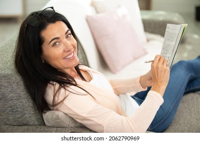 Beautiful Brunette Woman Doing A Crossword