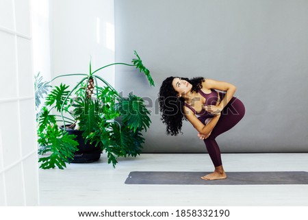 Beautiful brunette woman engaged in yoga sports fitness asana body flexibility