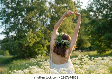 Beautiful brunette woman in flower wreath. Summer solstice day. Midsummer. - Shutterstock ID 2167694831