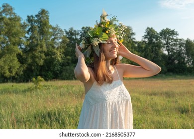 Beautiful brunette woman in flower wreath. Summer solstice day. Midsummer. - Shutterstock ID 2168505377