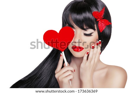 Beautiful Brunette Woman with Healthy Long Black Hair. Valentine girl. Beauty Glamour Fashion model portrait holding heart isolated on white background.