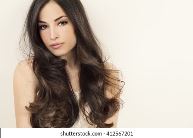 beautiful brunette woman with long healthy hair, studio white