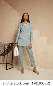 Beautiful brunette woman natural make up wear fashion clothes casual dress code office style blue jacket and pants suit for romantic date business meeting accessory bag interior boho stairs .