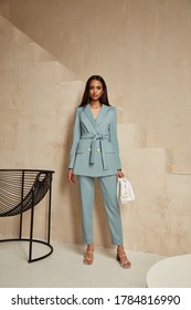 Beautiful Brunette Woman Natural Make Up Wear Fashion Clothes Casual Dress Code Office Style Blue Jacket And Pants Suit For Romantic Date Business Meeting Accessory Bag Interior Boho Stairs Flowerpot.