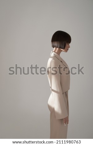 Beautiful brunette woman with natural makeup wear fashion pantsuit. Strict graphic bob haircut.  Business meeting