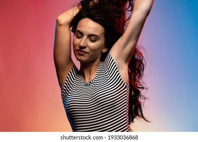 Beautiful Brunette Woman Portrait Wearing Black And White Stripes Body. Colored Gel Photography.