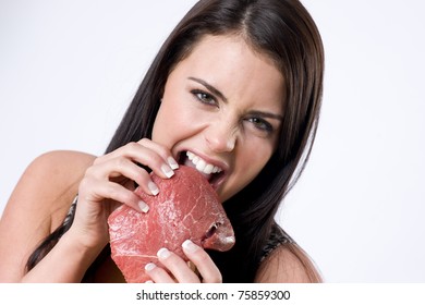 Beautiful Brunette Woman Ripping Raw Red Sirloin Steak Meat With her Teeth